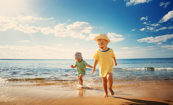 Boy and girl playing on the beach