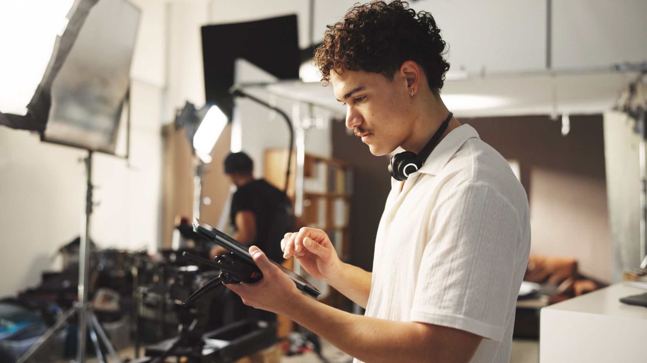 Young film producer working on set