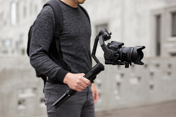 Guy using gimbal: Camera Stabilizers and Gimbals for Filmmakers