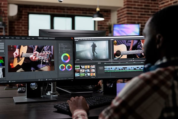 Video editor at desk: Best Stock Video Sites