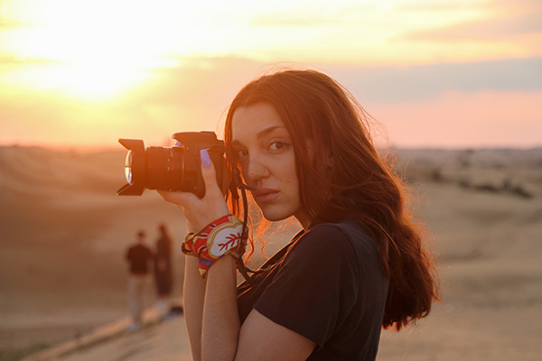 Girl with camera in hot weather: photography insurance Canada